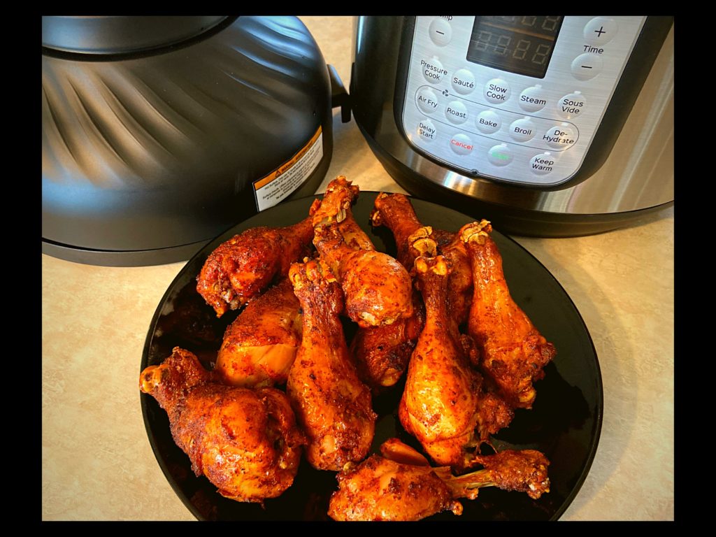 https://www.thepeculiargreenrose.com/wp-content/uploads/2020/02/A-black-plate-with-BBQ-chicken-Drumsticks-Instant-Pot-and-Instant-Pot-air-fryer-lid-all-sitting-on-top-of-a-kitchen-counter-1024x768.jpg
