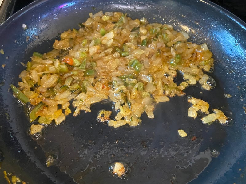 onion, bell pepper, and celery in a skillet after cooking